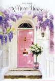 This welcoming doorway scene feels like discovering a hidden gem of a home just off Streatham Common, where flowers quietly tell the story of a fresh start. At the centre stands a pale pink door, its paint softly glowing in the afternoon light, with a matching shutter that mirrors its gentle blush. The walls around it are clean and whitewashed, catching the sun in a way that makes the whole façade appear bright yet tranquil. Above, cascades of lavender wisteria tumble down in luxurious, fragrant strands, each blossom curve forming a curtain that frames the door with natural grace. The interplay of sunlight and shade within the hanging flowers creates a dreamy patchwork of lilac tones and soft shadows. Resting patiently at the threshold is a vintage-style metal bucket in a muted grey, transformed into a vessel of celebration. It overflows with generous white and cream roses, their petals velvety and full, arranged so they nestle closely together like gathered wishes. Wisps of dusty green foliage and fresh leaves weave among the roses, adding depth and texture while keeping the palette calm and elegant. A soft pink ribbon is tied around the bucket, its satin tails trailing lightly across the step, echoing both the colour of the door and the romantic mood of the scene. The overall feeling is one of tender anticipation, as though these flowers were delivered by a thoughtful Streatham florist to mark the joy of moving day-a simple, heartfelt gesture to bless a new home, soothe anxious hearts, and whisper a gentle message of comfort, good fortune, and enduring welcome.